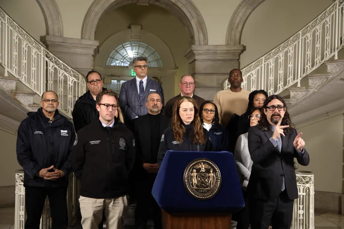 Leaders stand in the City Hall rotunda.