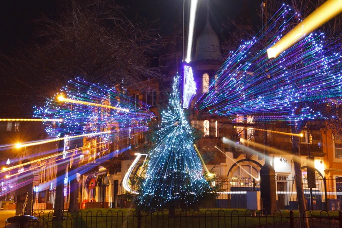 Christmas tree and lights in Burntisland High Street at night, with the lights turned into long streaks due to zooming the lens during the 5 second exposure 