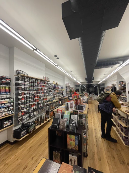 Wide shot of a retail store selling board games and ttrpgs