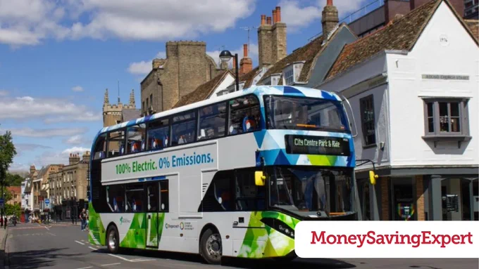 A local bus travelling through a town centre.
