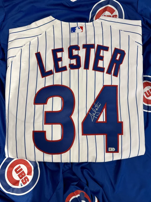 A Cubs pinstripe jersey with LESTER and 34 on the back. Jon Lester’s autograph and an authentication sticker are inside the 4.
