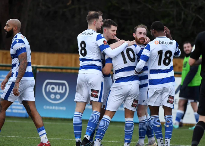 Oxford City players celebrate in huddle