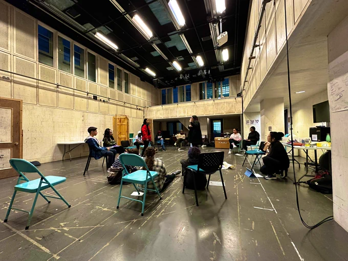 Donmar warehouse rehearsal room with a group of young people and directors