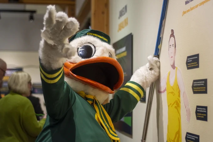 The Duck mimes throwing a javelin at the Natural Athletes exhibit. 
