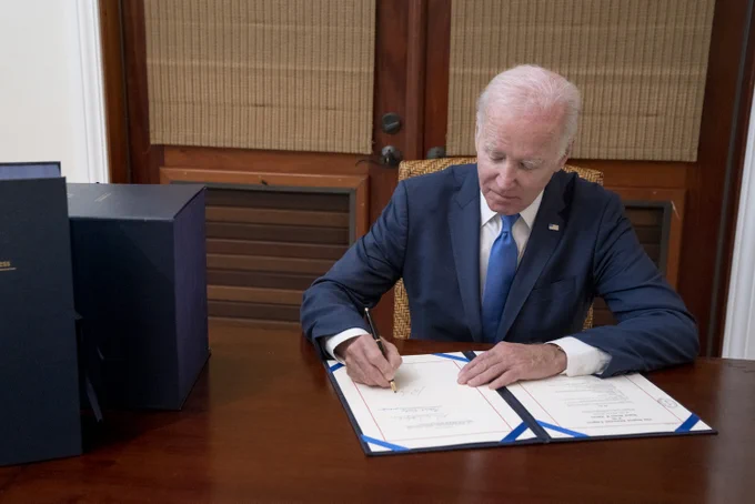 President Biden signs the bipartisan omnibus bill into law. 