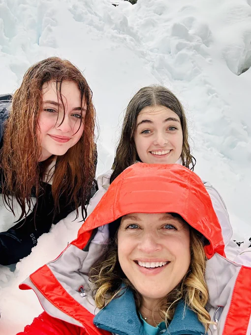 Mom and two teen daughters in the snow.