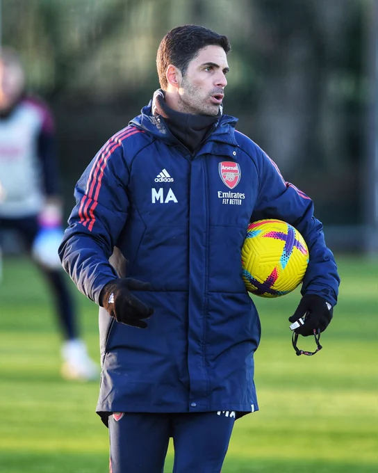 Mikel Arteta holding a ball and whistle during training today at London Colney.
