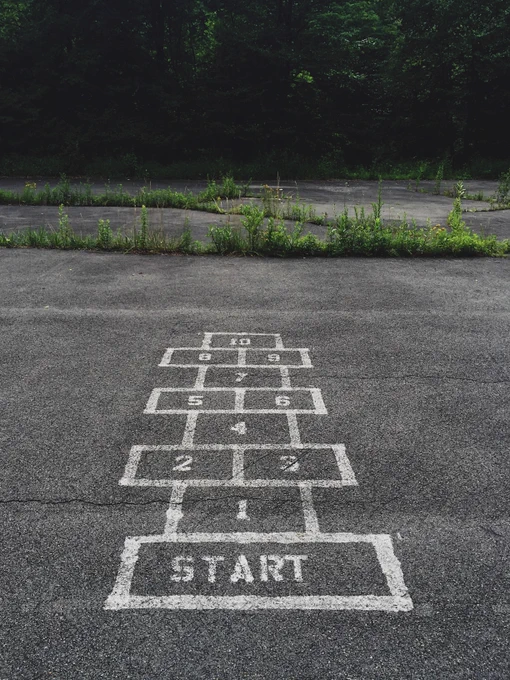 Thanks to Jon Tyson on Unsplash for this photograph of a hop-scotch game drawn in an overgrown playground, the word 'start' in the first box.