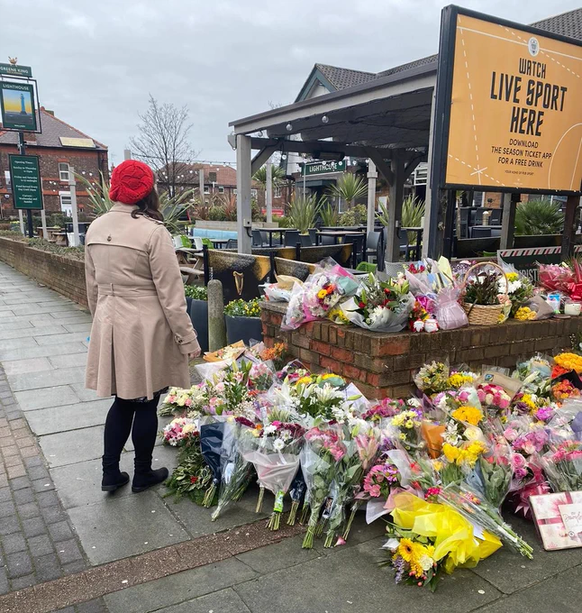 PCC Emily Spurrell reading the tributes outside the Lighthouse Pub in Wallasey Village