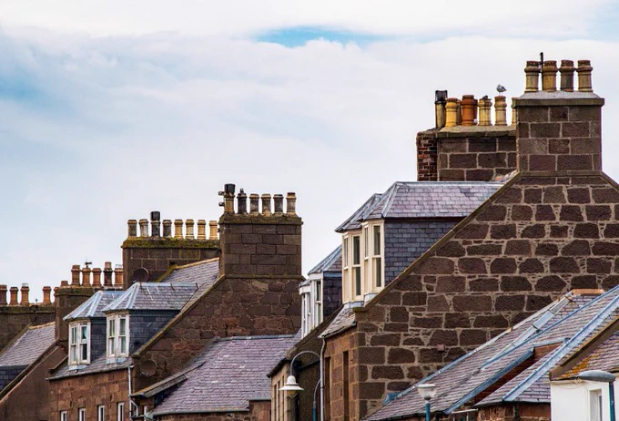 The rooftops of houses with chimneys 