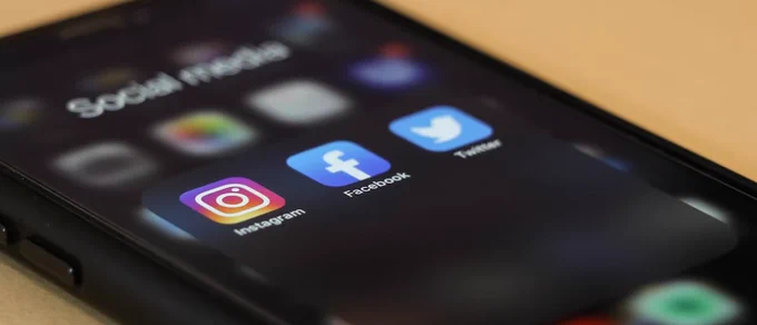 Photo of a phone with the social media icons highlighted. 