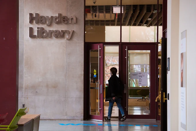 Person walking into Hayden library.