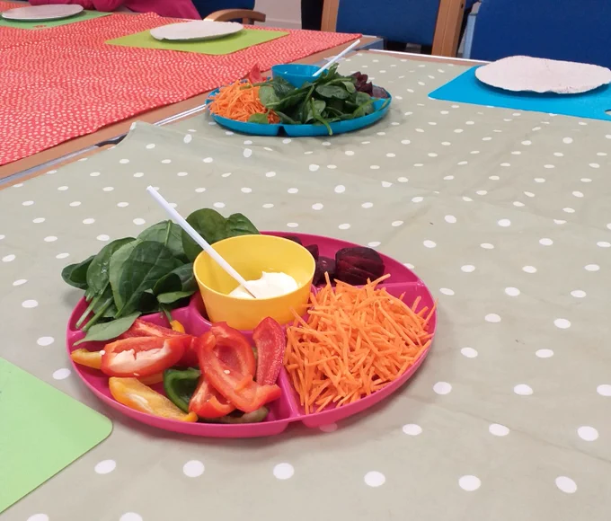 Colourful platter of ingredients for making wraps - cream cheese, carrot, peppers, spinach, beetroot