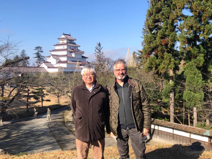 [Image description: Albert van der Vliet, Ph.D. (right), with Takaaki Akaike, M.D., Ph.D. (left), standing near the Tsuruga-Jo castle in Aizu, Japan.]