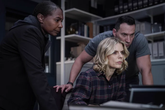 Image shows Torres, Nikki Alexander and Jack Hodgson looking at a computer screen.