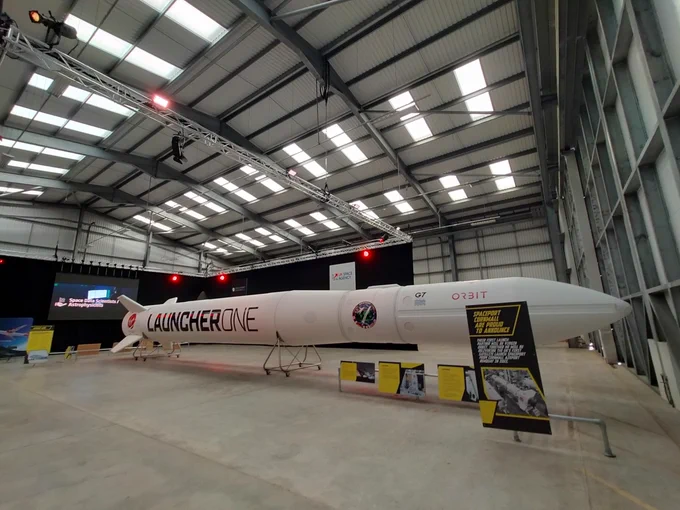 Photo of Launcher One rocket inside an airport hanger