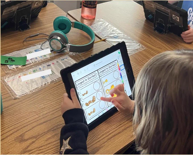 Student completing activity on Seesaw.
