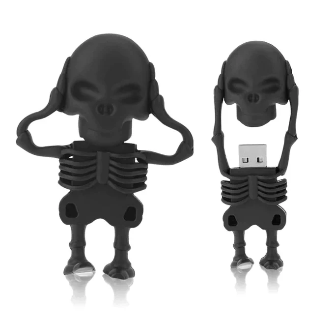 Two black rubber skeleton shaped flash drives. The skeleton appears to hold his skull in his hands. The skull is the cap over the USB connector, so when the skull is removed from the torso, the hands remain attached to the skull and the arms keep it loosely attached to the torso.