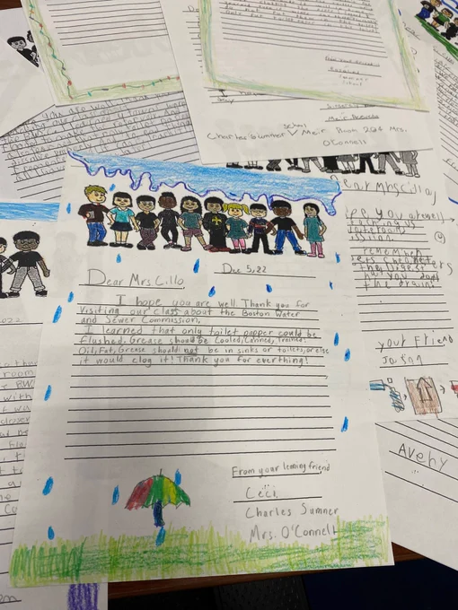 Picture of letters written by students. Drawing of rain and an umbrella.  