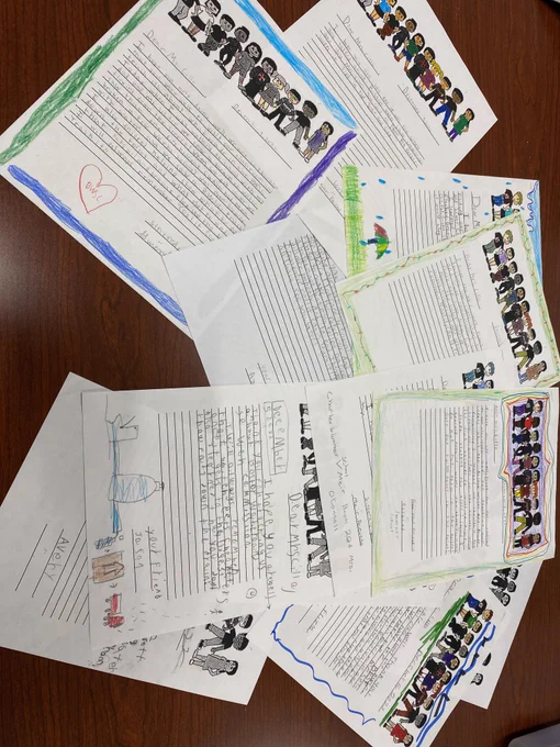 Photo with many letters of students saying thank many with colorful designs.