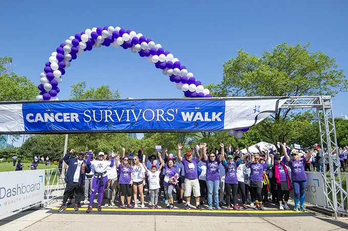 People lined up under a finish line banner that says "Cancer Survivors' walk" at the Lurie Cancer Center’s 2019 Cancer Survivors’ Celebration Walk & 5K. Photo from Northwestern's Lurie Cancer Center website.
