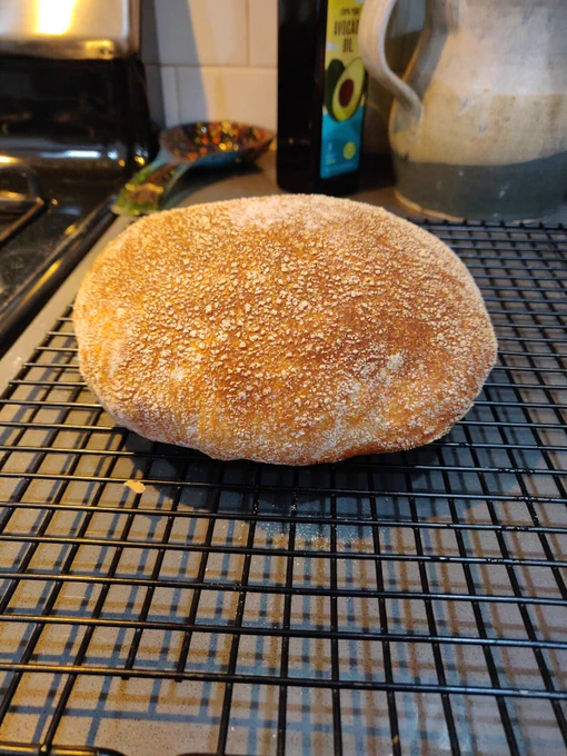 Loaf of bread cooling on a wire rack 