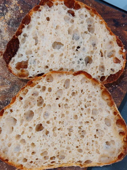Loaf of bread sliced open revealing an airy crumb