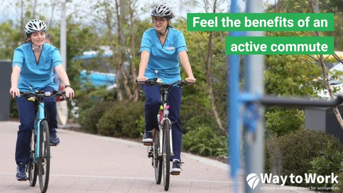 Two NHS workers cycling on a path outside their workplace, with overlayed text reading 'Feel the benefits of an active commute'.