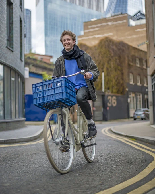 A man smiling while riding his bike