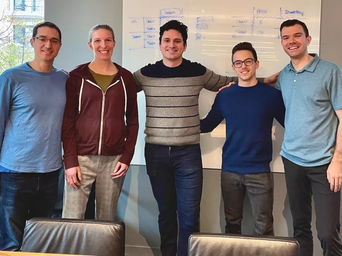 The Spindle product team poses joyfully afront a whiteboard at Accel Partners in Palo Alto.