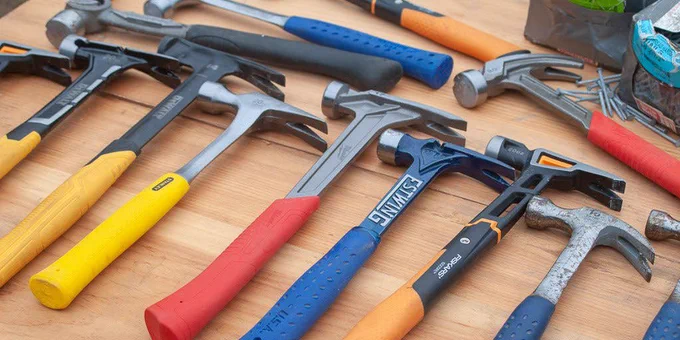 Row of similar hammers on a table.