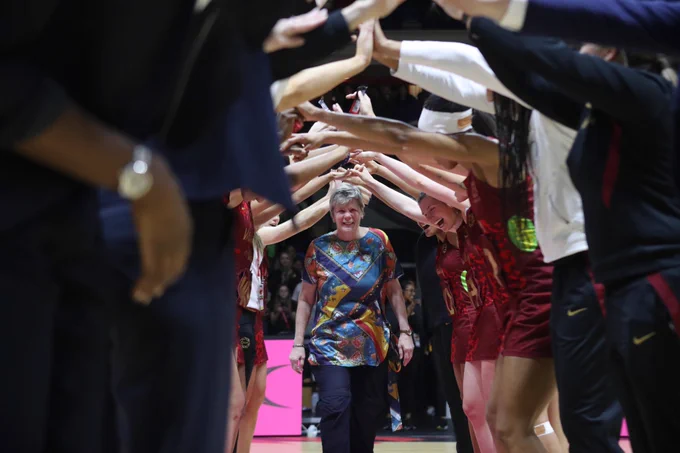 Colette Thomson MBE walks through the guard of honour formed by the Vitality Roses