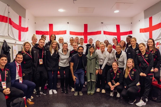 The Vitality Roses and Performance team pose with Malala after the second game of the Vitality Netball International Series