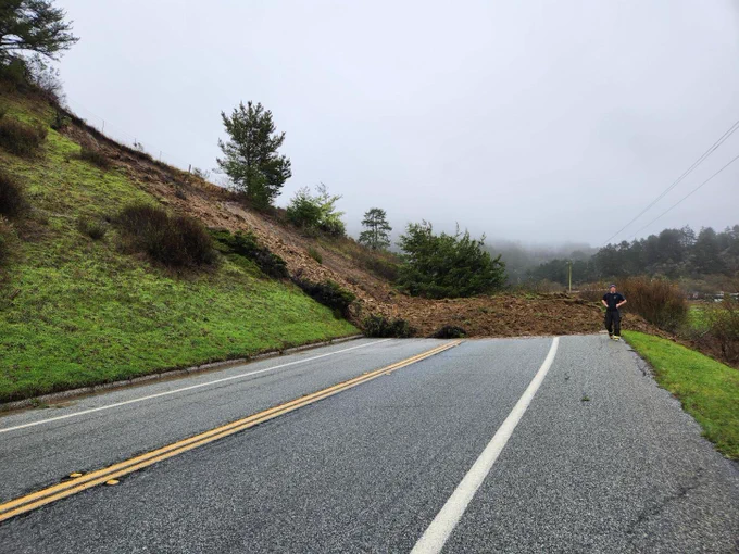 Street and mudslide with firefighter in the distance