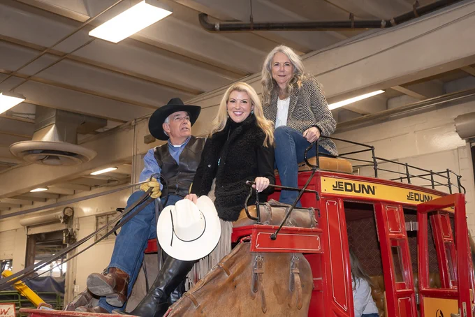 C S U President Amy Parsons sitting on top of a carriage with two other people.