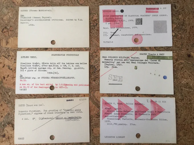 6 old library catalogue cards, some with experimental printing on