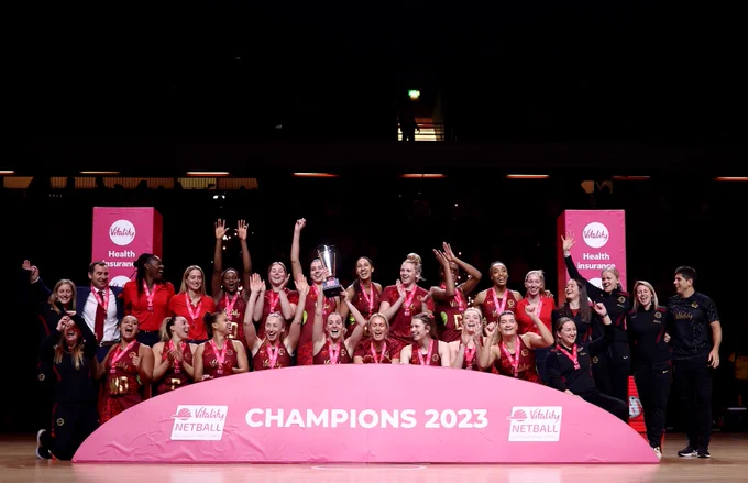 The Vitality Roses and Performance staff celebrate as they lift the trophy