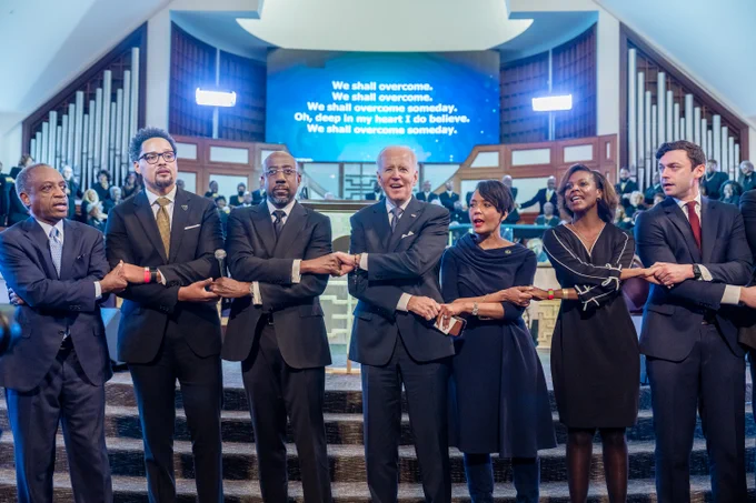 President Biden joins hands with Senator Reverend Warnock and church leaders at Ebenezer Baptist Church in honor of Dr. Martin Luther King, Jr.