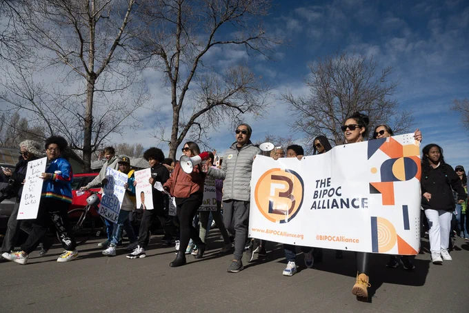 M L K Day March led members of The BIPOC Alliance holding a sign that says, "The BIPOC Alliance." 