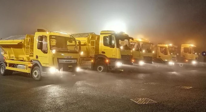 Fleet of gritters at night