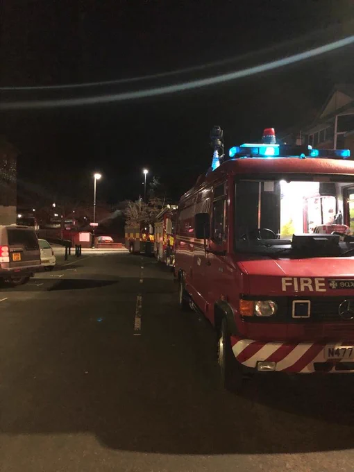 Fire engines lined up outside a night time incident