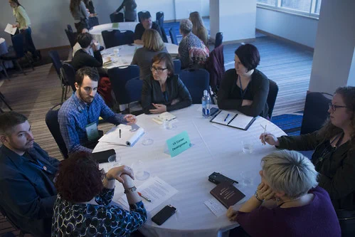 practitioners conversing at a round table 