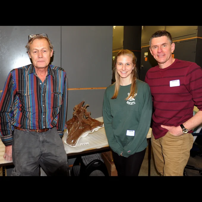 The late Bob Harmon in March 2017 with the braincase of the T. rex he discovered nicknamed B-rex (MOR 1125), along with Ohio University undergrad Emily Caggiano and me (Witmer). I wanted to introduce the students with me to this unassuming legend and insisted on this photo, even if Bob couldn't see what all the fuss was about. 