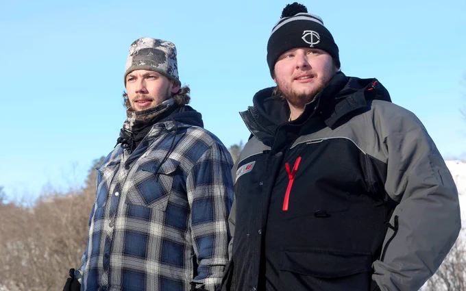 Sam Riola, a redshirt senior infielder/righthanded pitcher with the St. Cloud State University baseball team, left, and Reid Conlee, a St. Cloud State University baseball alum, watch near the starting line at Billy's in Duluth Sunday, Jan. 29, 2023 during the 2023 John Beargrease Sled Dog Marathon. They were part of a group of  teammates and friends of Ero Wallin's at SCSU that traveled to cheer Wallin on. Wallin is a redshirt freshman infielder for the Huskies.
Dan Williamson / Duluth News Tribune