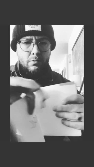 man turning notebook page