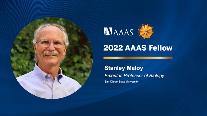 Blue background with white text announcing Stanley Maloy as a 2022 AAAS fellow with a photo of him smiling outside