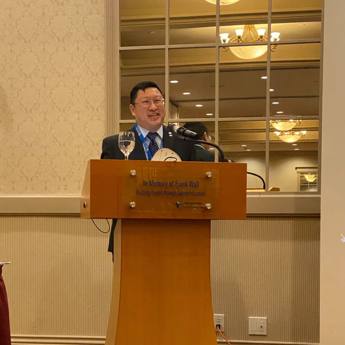 Kane smiles while speaking at the lectern