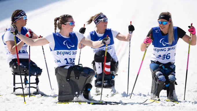 Oksana Masters and her teammates together on skis.
