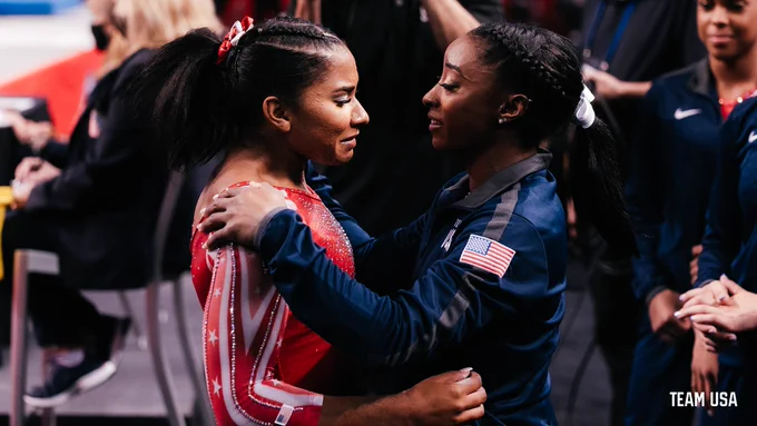 Simone Biles embraces Jordan Chiles following a routine. 