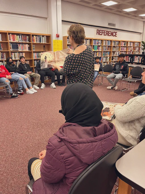 Mrs. B reading aloud while students listen and enjoy